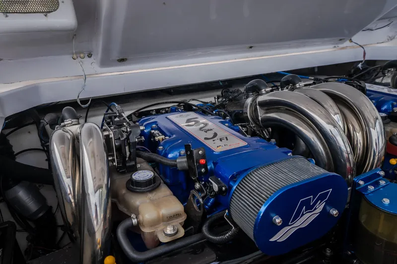 Slide: The Image of 2005 Donzi 35 ZR engine with blue components and polished metal pipes. - 37