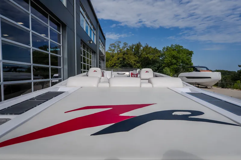 Slide: The Image of 2005 Donzi 35 ZR boat with sleek design, parked near a modern building. - 17