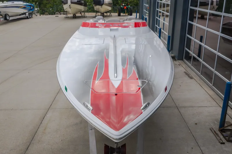 Slide: The Image of 2005 Donzi 35 ZR speedboat with red and white design, parked outdoors. - 8