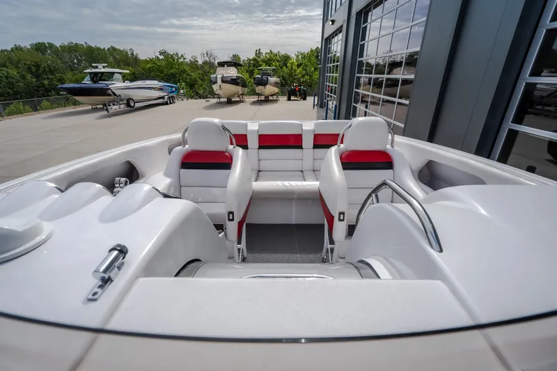 Slide: The Image of 2005 Donzi 35 ZR boat interior with white and red seating, parked near other boats. - 46