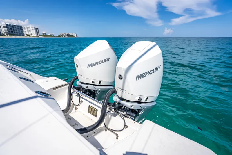 Slide: The Image of 2006 Boston Whaler 320 Outrage with twin Mercury outboard engines on blue ocean. - 65