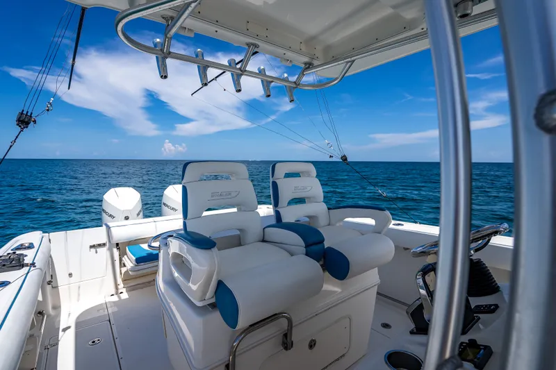 Slide: The Image of 2006 Boston Whaler 320 Outrage boat interior with ocean view and fishing equipment. - 38