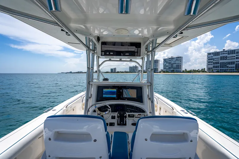 Slide: The Image of 2006 Boston Whaler 320 Outrage boat interior with ocean and coastal buildings in view. - 50