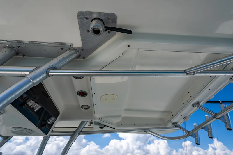 Slide: The Image of 2006 Boston Whaler 320 Outrage boat canopy with metal framework against blue sky. - 43
