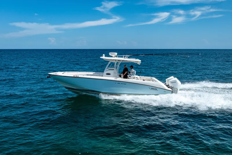 Slide: The Image of 2006 Boston Whaler 320 Outrage cruising on open ocean under clear blue sky. - 13