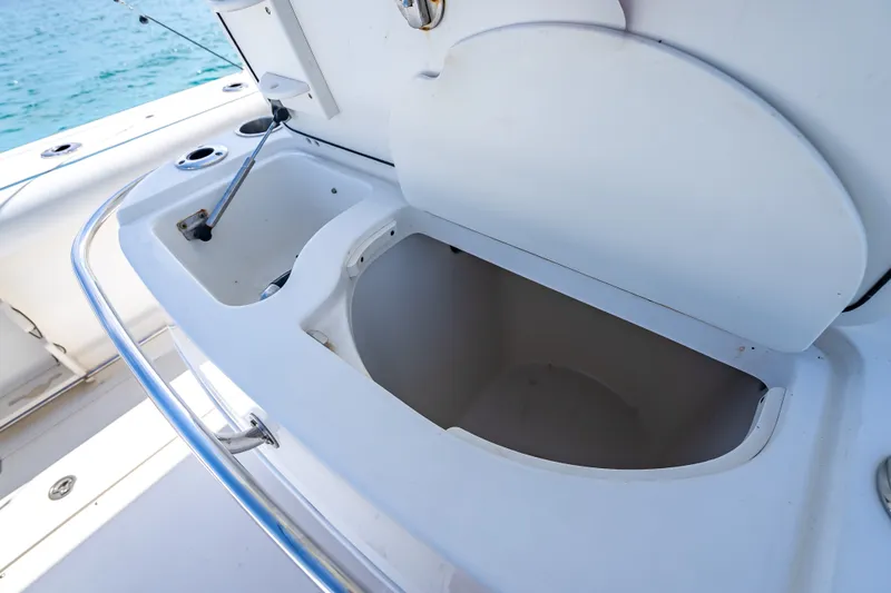 Slide: The Image of Open storage compartment on a 2006 Boston Whaler 320 Outrage boat. - 58