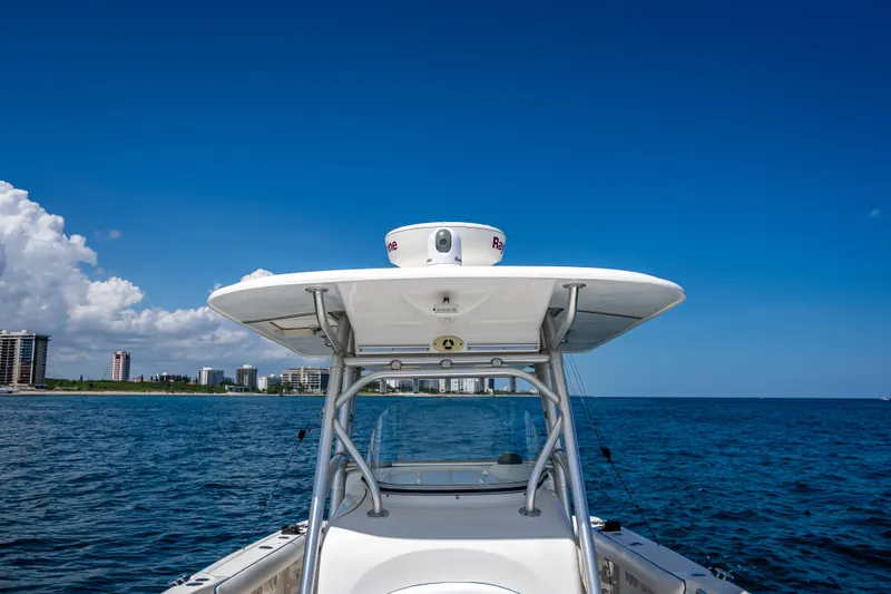Slide: The Image of 2006 Boston Whaler 320 Outrage boat on ocean with city skyline background. - 28