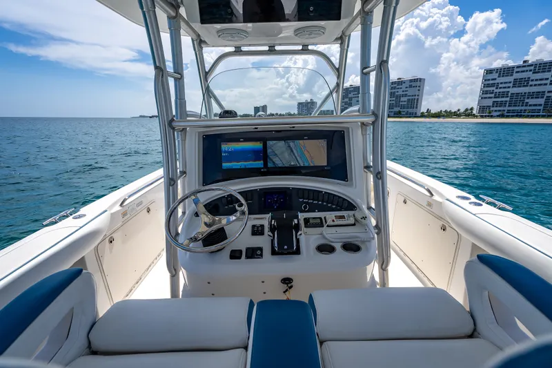 Slide: The Image of 2006 Boston Whaler 320 Outrage boat cockpit with ocean view and modern navigation equipment. - 48