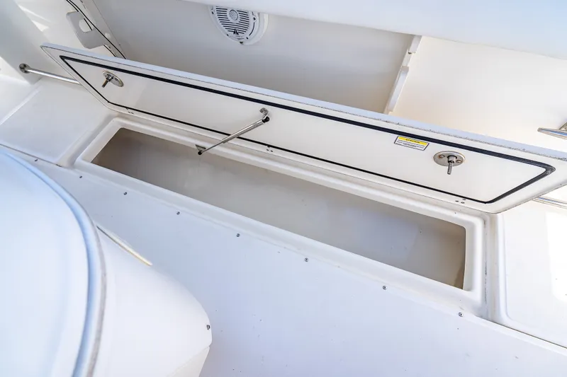 Slide: The Image of Open storage compartment on a 2006 Boston Whaler 320 Outrage boat. - 61