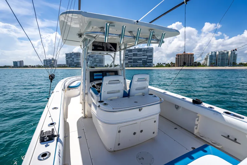 Slide: The Image of 2006 Boston Whaler 320 Outrage boat on water with city skyline in background. - 56