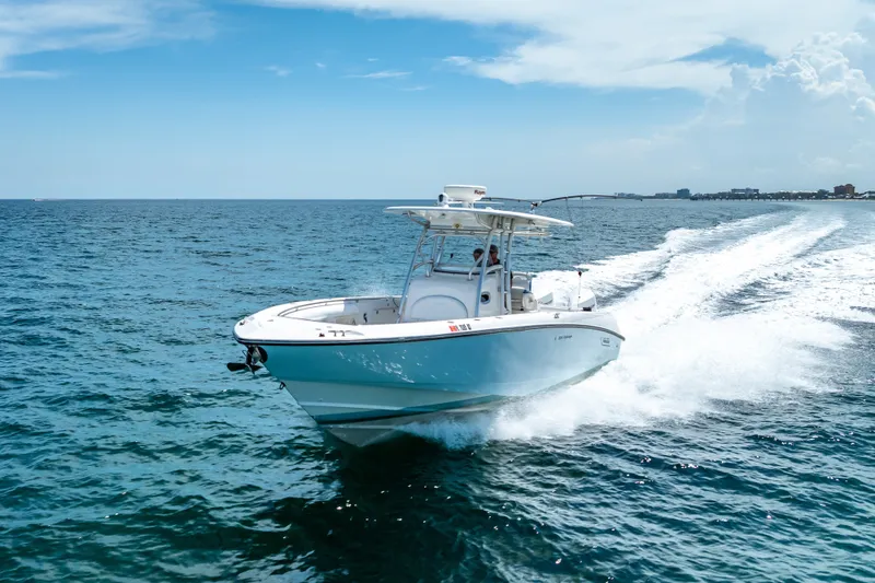 Slide: The Image of 2006 Boston Whaler 320 Outrage cruising on open ocean under clear blue sky. - 16