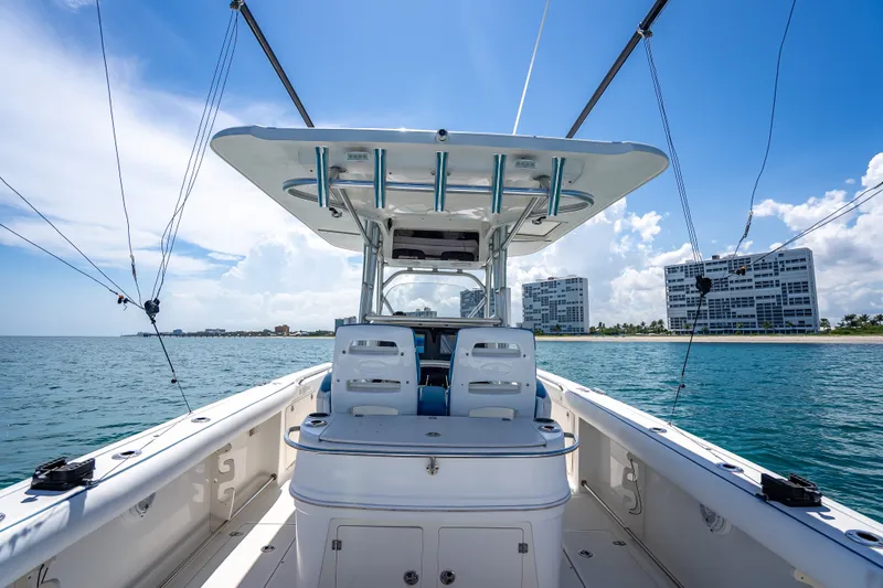 Slide: The Image of 2006 Boston Whaler 320 Outrage boat on water, with cityscape in background. - 54