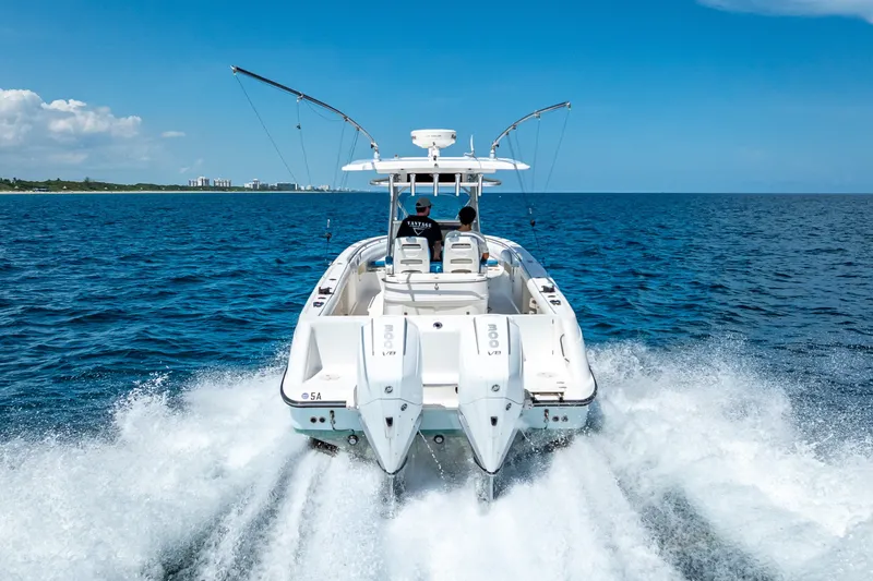 Slide: The Image of 2006 Boston Whaler 320 Outrage cruising on open ocean under clear blue sky. - 20