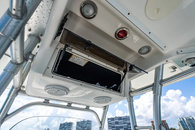Slide: The Image of 2006 Boston Whaler 320 Outrage boat console with open storage compartment and speakers. - 46
