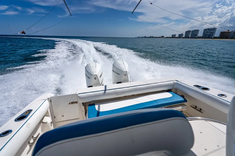 Slide: The Image of 2006 Boston Whaler 320 Outrage cruising on open water, leaving a wake behind. - 67