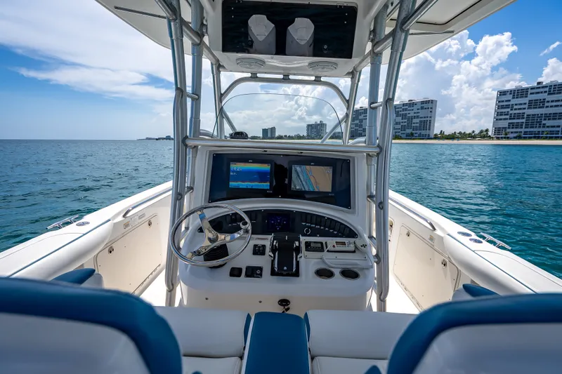 Slide: The Image of 2006 Boston Whaler 320 Outrage boat dashboard with ocean view and modern navigation equipment. - 49