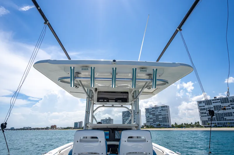 Slide: The Image of 2006 Boston Whaler 320 Outrage boat on water with clear blue sky background. - 55