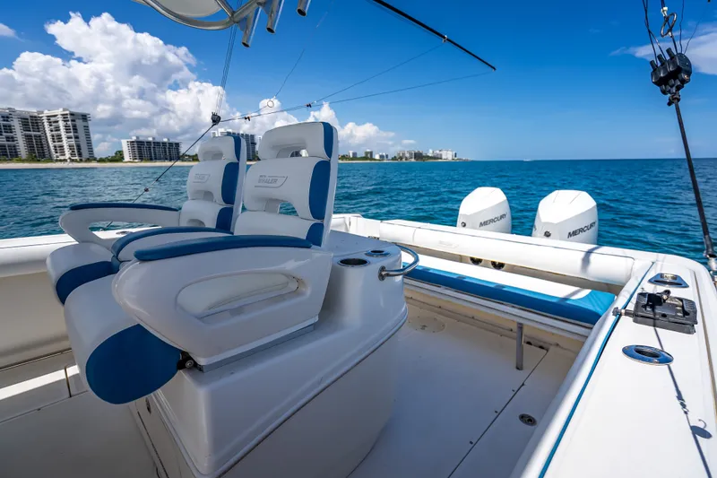 Slide: The Image of 2006 Boston Whaler 320 Outrage boat with dual Mercury engines on open water. - 41