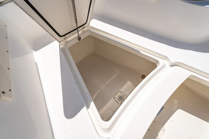 Slide: The Image of Storage compartment on a 2006 Boston Whaler 320 Outrage boat, open and empty. - 35