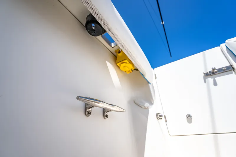 Slide: The Image of 2006 Boston Whaler 320 Outrage boat detail with cleat and blue sky background. - 62