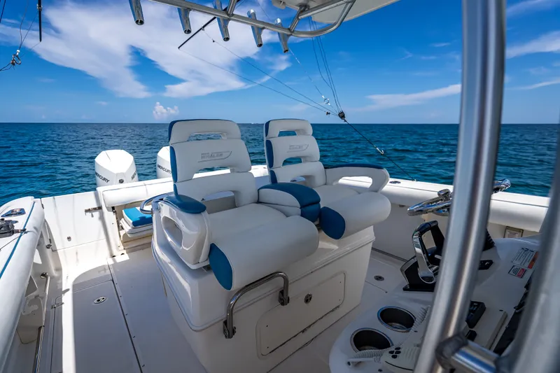 Slide: The Image of 2006 Boston Whaler 320 Outrage boat interior with ocean view and fishing equipment. - 37