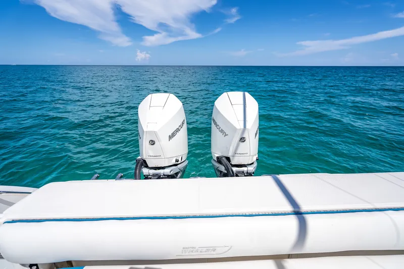 Slide: The Image of 2006 Boston Whaler 320 Outrage with twin Mercury engines on open sea. - 64