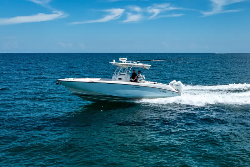 Slide: The Image of 2006 Boston Whaler 320 Outrage cruising on open ocean under clear blue sky. - 14