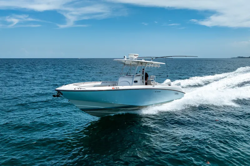 Slide: The Image of 2006 Boston Whaler 320 Outrage cruising on open ocean under clear blue sky. - 15
