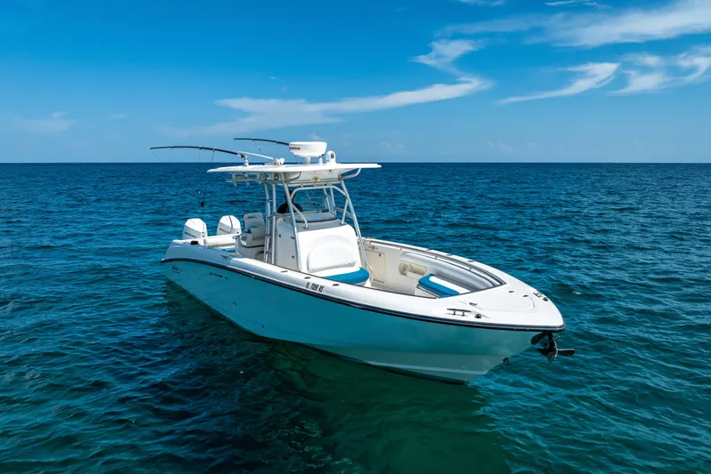 The Image of 2006 Boston Whaler 320 Outrage boat on open ocean under clear blue sky. - 0