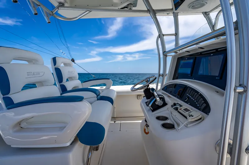 Slide: The Image of 2006 Boston Whaler 320 Outrage boat interior with ocean view and control panel. - 39