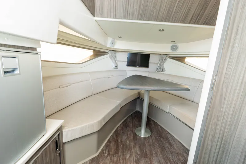 Slide: The Image of Interior of a 2024 Sea Ray Sundancer 320 Outboard with elegant seating area and table. - 24