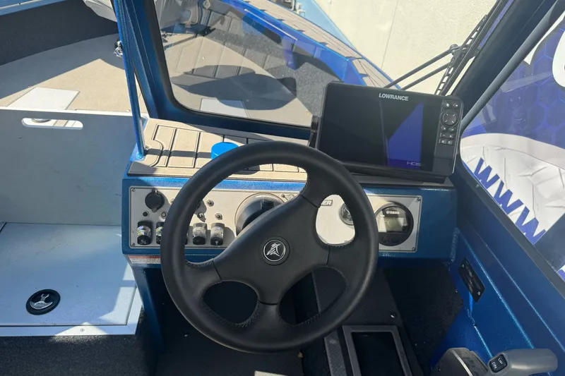 Slide: The Image of 2023 KingFisher 1825 Warrior Sport dashboard with steering wheel and Lowrance HDS display. - 17