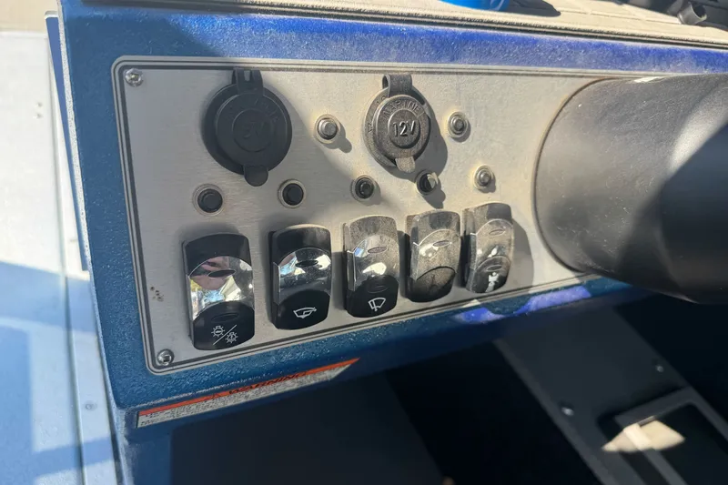 Slide: The Image of Control panel of 2023 KingFisher 1825 Warrior Sport boat with switches and sockets. - 26