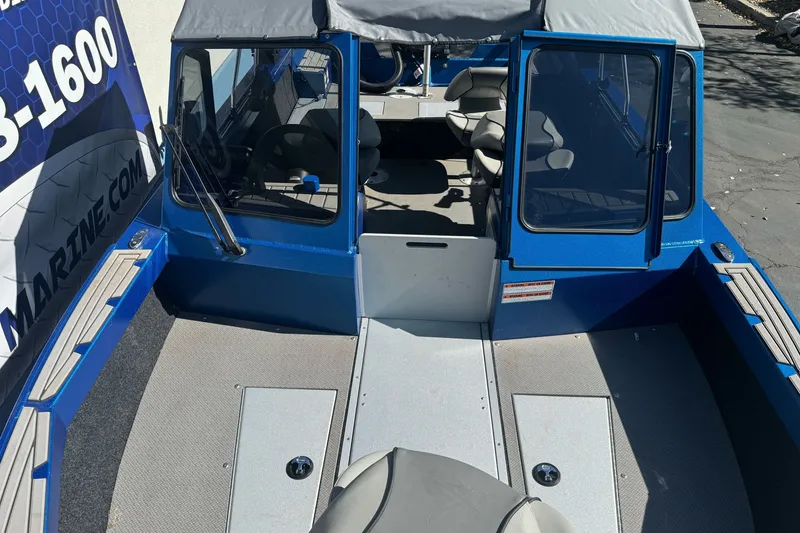 Slide: The Image of 2023 KingFisher 1825 Warrior Sport boat interior with blue exterior and seating. - 24