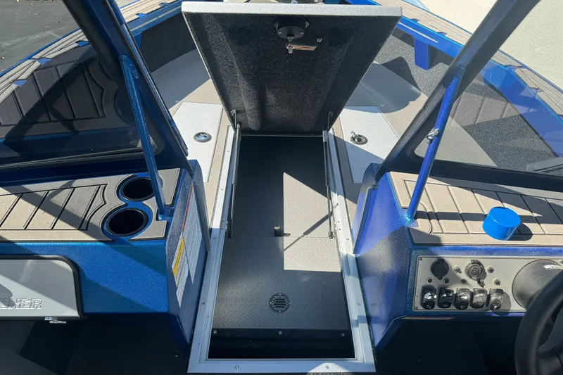 Slide: The Image of 2023 KingFisher 1825 Warrior Sport boat interior with open storage compartment and control panel. - 25
