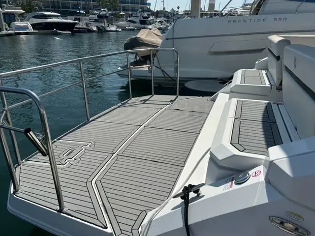 Slide: The Image of The 2018 Cruisers Yachts 39 Express Coupe features a spacious aft deck with sleek gray flooring. - 32