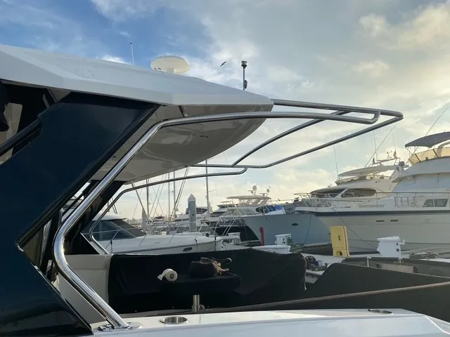 Slide: The Image of The 2018 Cruisers Yachts 39 Express Coupe is docked, surrounded by other yachts. - 33