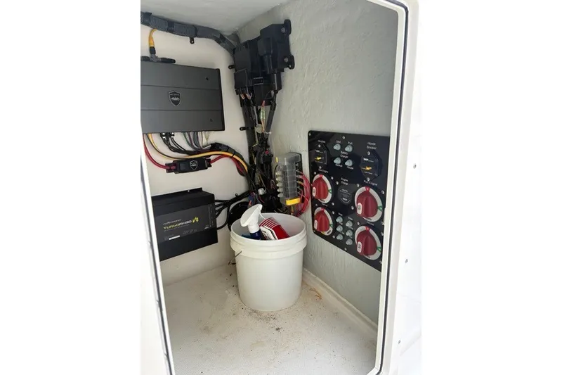 Slide: The Image of Electrical panel and wiring inside a 2021 Century 24 Resorter boat compartment. - 52
