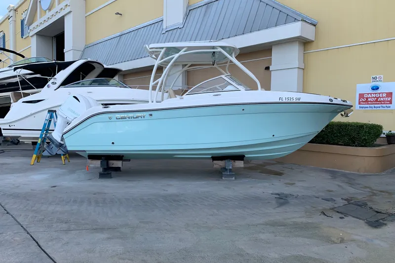 Slide: The Image of 2021 Century 24 Resorter boat displayed on stands outside a building. - 14