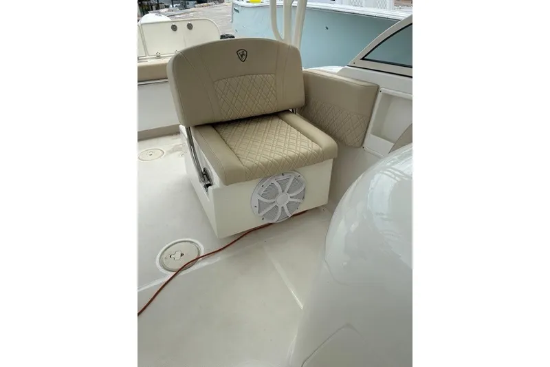 Slide: The Image of 2021 Century 24 Resorter boat interior with beige seating and speaker. - 43