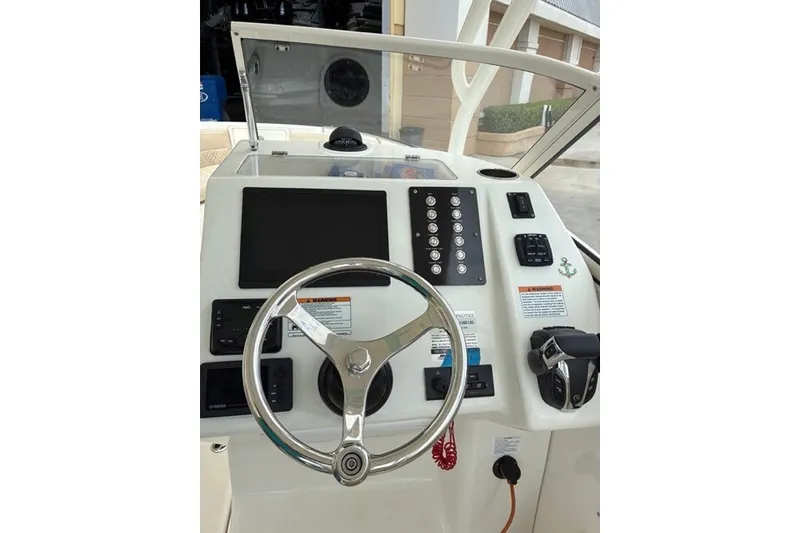 Slide: The Image of Steering console of a 2021 Century 24 Resorter boat with modern controls. - 34