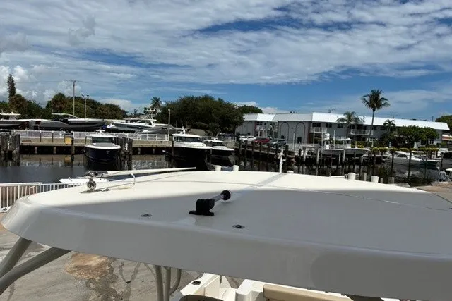 Slide: The Image of 2021 Century 24 Resorter boat docked at a marina under a partly cloudy sky. - 29
