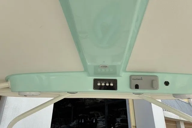 Slide: The Image of 2021 Century 24 Resorter boat dashboard with Garmin controls and switches. - 27