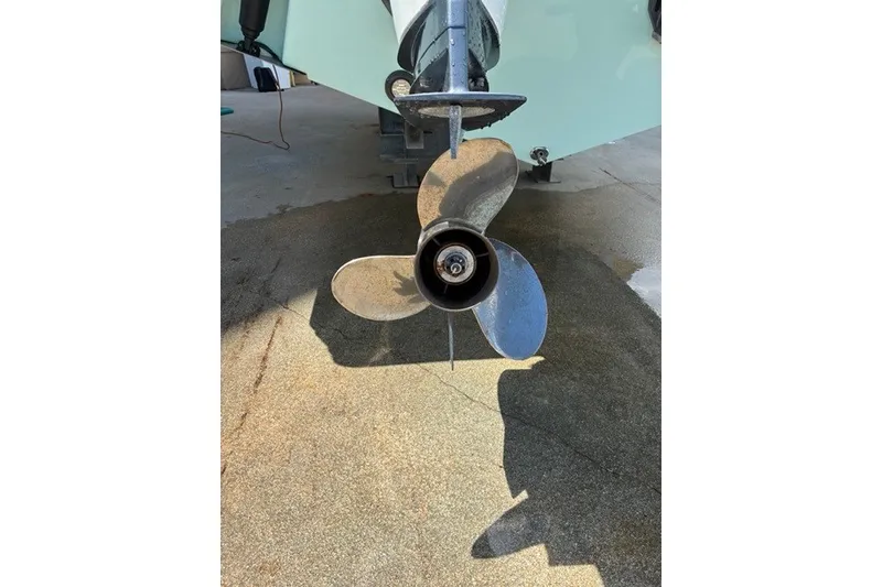 Slide: The Image of Propeller of a 2021 Century 24 Resorter boat on a concrete surface. - 21