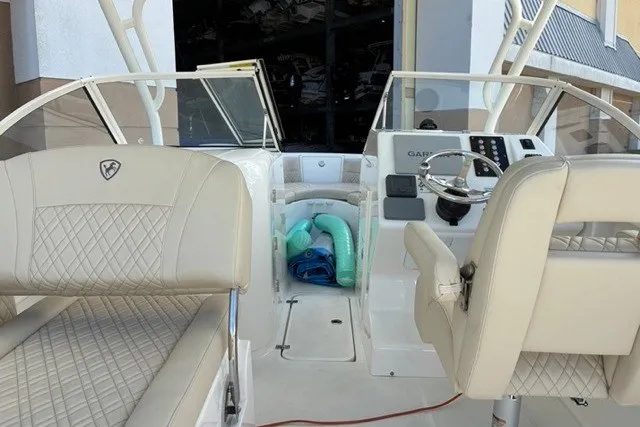Slide: The Image of 2021 Century 24 Resorter boat interior with beige seating and steering console. - 39