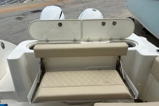 Slide: The Image of 2021 Century 24 Resorter boat with beige seating and dual outboard motors. - 47