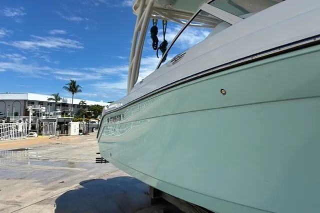 Slide: The Image of 2021 Century 24 Resorter boat docked under clear blue sky. - 24