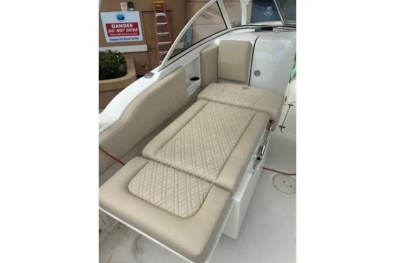 Slide: The Image of 2021 Century 24 Resorter boat with beige cushioned seating and quilted design. - 45