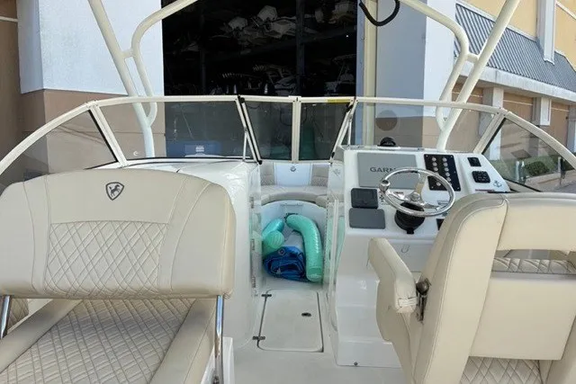 Slide: The Image of 2021 Century 24 Resorter boat interior with beige seating and modern dashboard. - 59