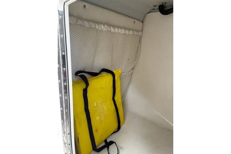 Slide: The Image of Yellow life jacket in storage compartment of 2021 Century 24 Resorter boat. - 57